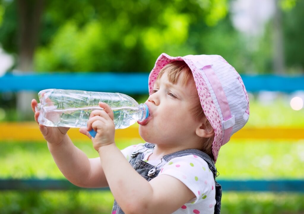 two year child drinks from bottle